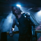 Johnny Silverhand leans on a railing.